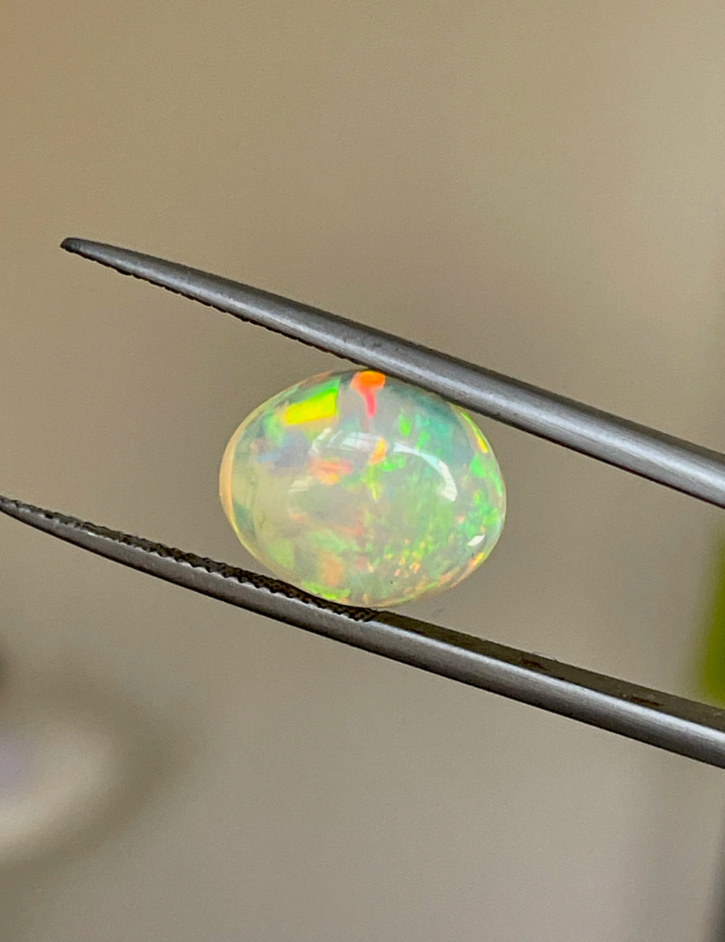 3.6 carats Oval Ethiopian Opal Cabochon with vibrant play of colors and smooth polished surface