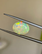 3.6 carats Oval Ethiopian Opal Cabochon with vibrant play of colors and smooth polished surface