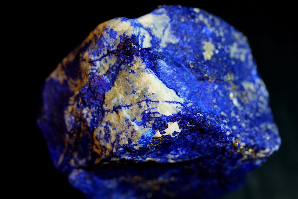 A close-up of a blue Lapis Lazuli with  cream-colored mineral specimen, lapis lazuli