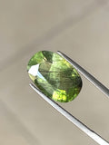 Close-up of rare 8.2ct Ludwigite Peridot with black needle inclusions