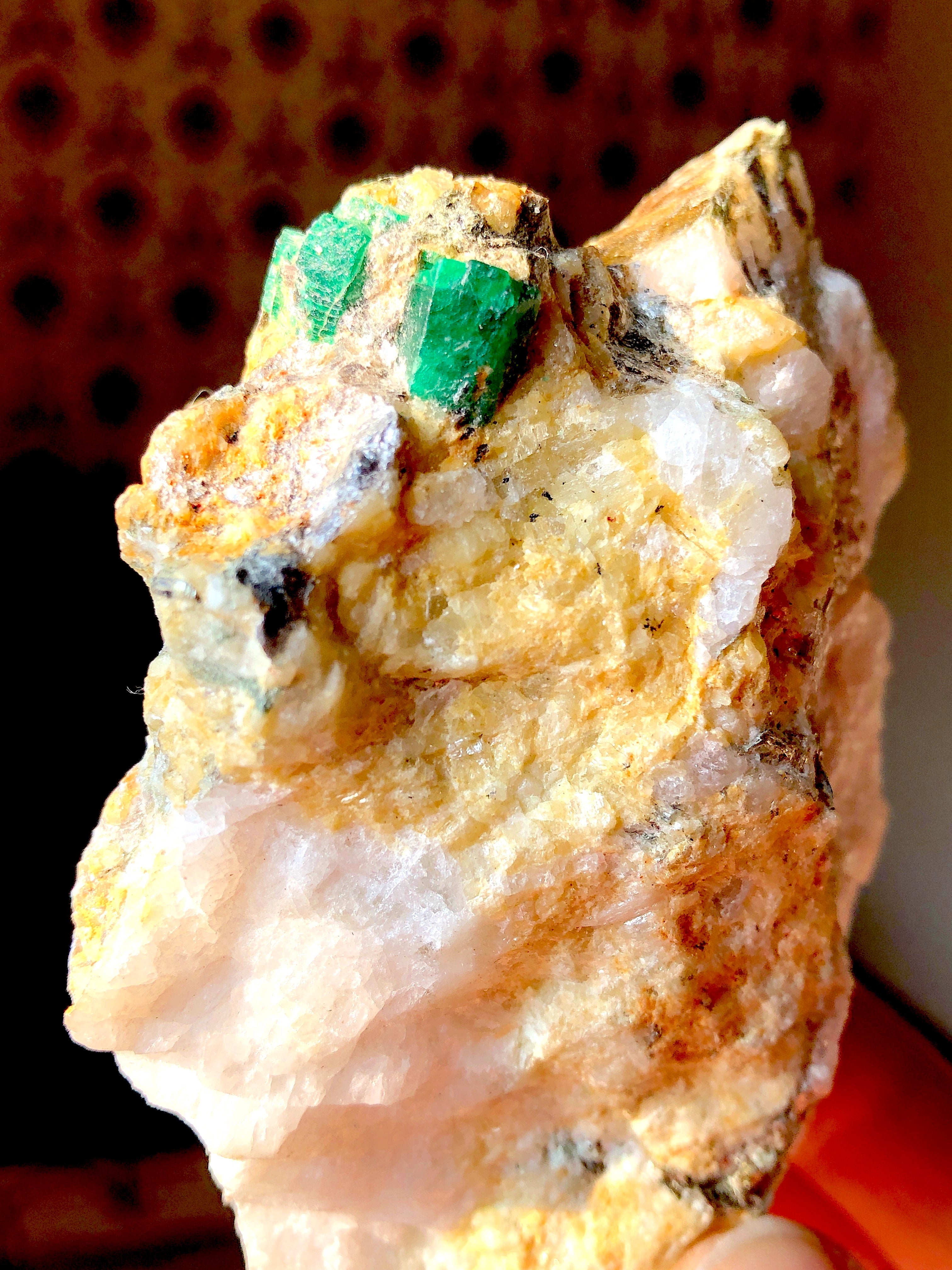 Mineral sample with green emerald crystals on metrix