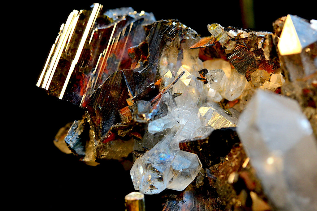 A close-up of a mineral specimen featuring metallic gold