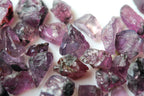 A close-up of  faceting raw purple batakundi kashmir sapphires value
