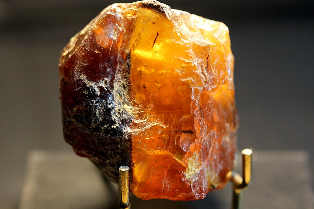 A raw amber-colored mineral specimen